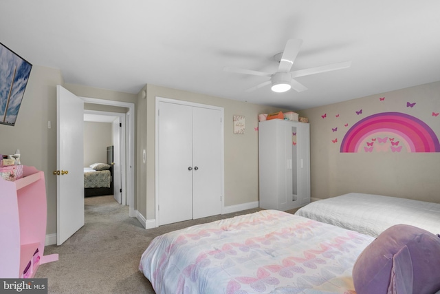 bedroom featuring a closet, baseboards, a ceiling fan, and carpet flooring