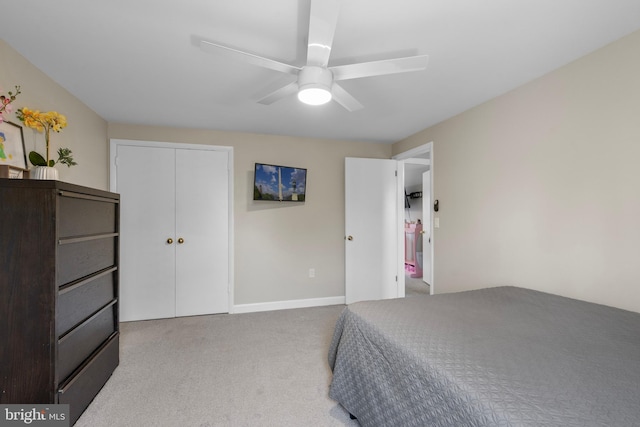 carpeted bedroom featuring a closet, baseboards, and ceiling fan