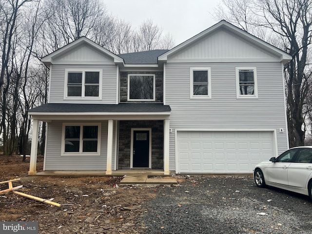 21 Piute Trl, Albrightsville, PA 18210 - view of front facade featuring an attached garage, covered porch, stone siding, a shingled roof, and driveway