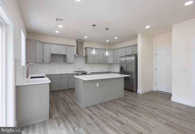 21 Piute Trl, Albrightsville, PA 18210 - kitchen with appliances with stainless steel finishes, gray cabinets, a kitchen island, wall chimney exhaust hood, and a sink