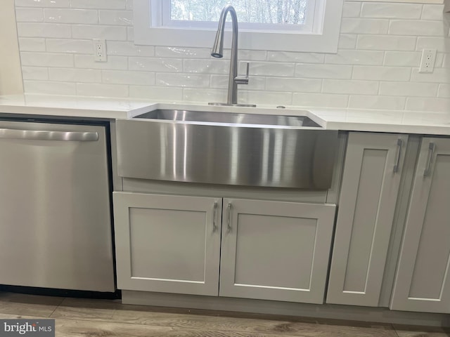 21 Piute Trl, Albrightsville, PA 18210 - detailed view of stainless steel dishwasher, gray cabinetry, a sink, and backsplash
