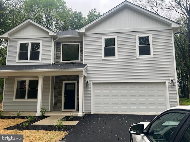21 Piute Trl, Albrightsville, PA 18210 - view of front of house with covered porch, asphalt driveway, a garage, and stone siding