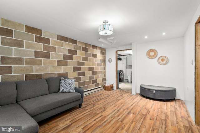 living room with a baseboard radiator, wood finished floors, and recessed lighting