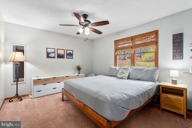 bedroom with carpet, a textured ceiling, and a ceiling fan