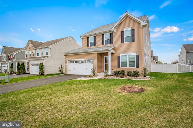 traditional home with aphalt driveway, roof with shingles, fence, and a front yard