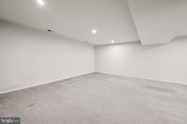 finished below grade area featuring recessed lighting, carpet flooring, visible vents, and baseboards
