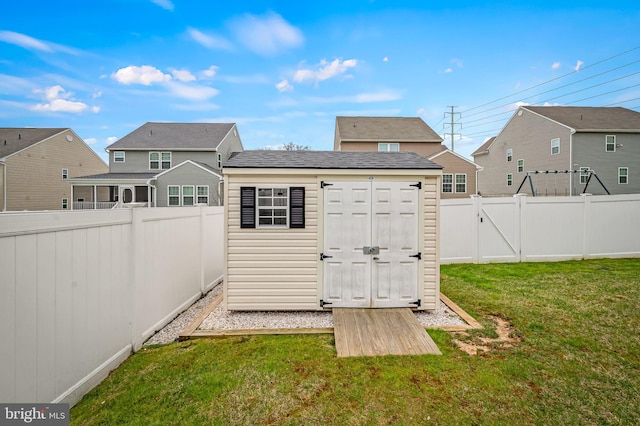 view of shed featuring a residential view and a fenced backyard