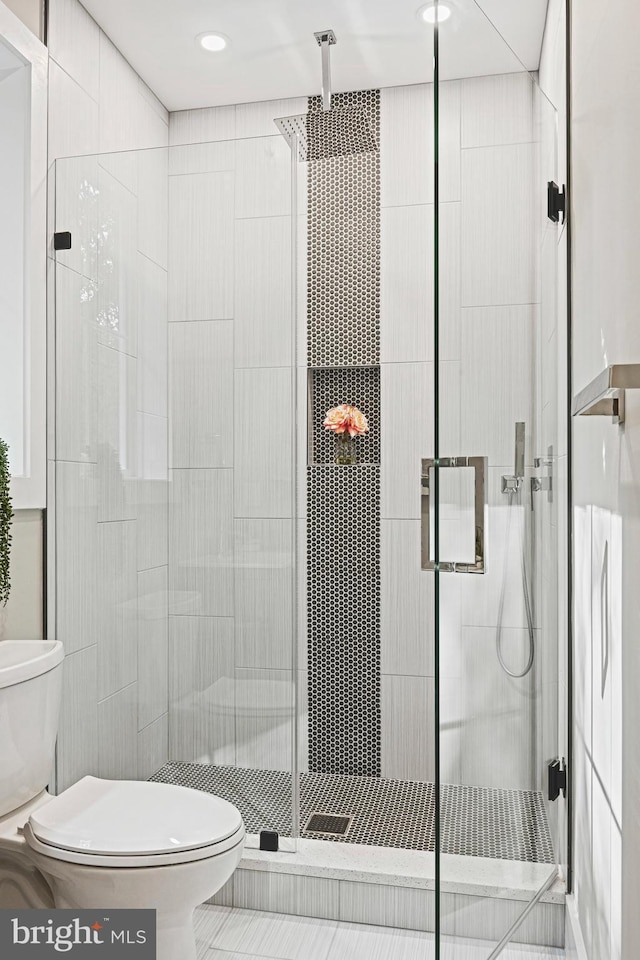 full bath with recessed lighting, a shower stall, and toilet