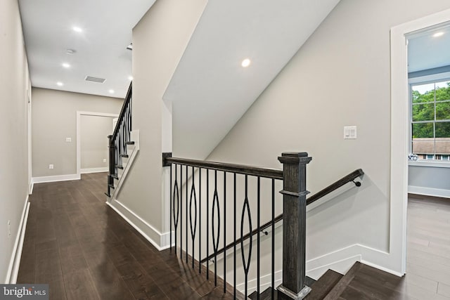 stairway with baseboards, wood finished floors, and recessed lighting