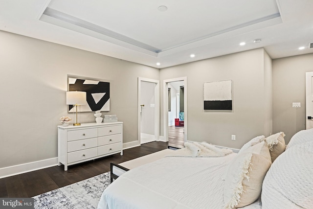 bedroom featuring recessed lighting, baseboards, dark wood-style flooring, and a tray ceiling