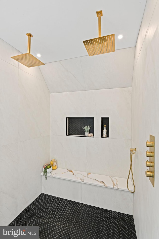 full bath featuring tile walls, recessed lighting, tile patterned flooring, and tiled shower