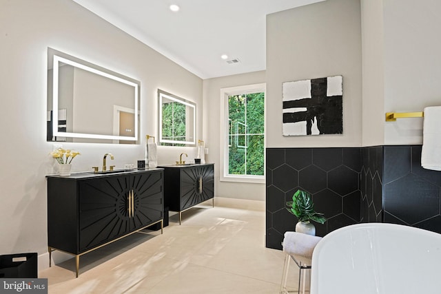 full bath featuring recessed lighting, a freestanding tub, tile patterned floors, and vanity