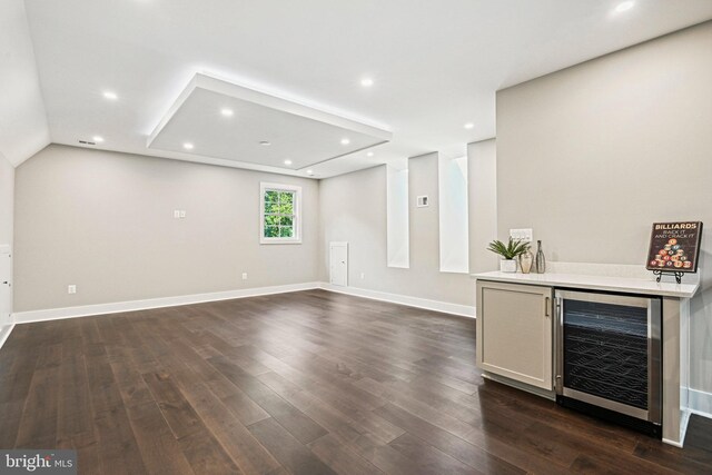 bar with a dry bar, dark wood-style floors, baseboards, recessed lighting, and beverage cooler