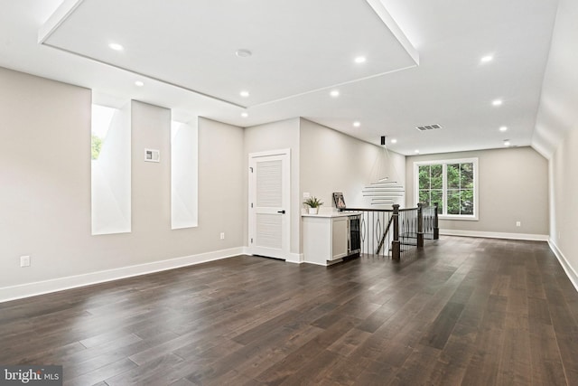 unfurnished living room featuring visible vents, recessed lighting, and dark wood-type flooring