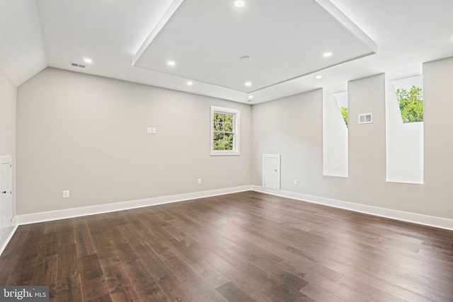 empty room featuring baseboards, dark wood-type flooring, visible vents, and recessed lighting