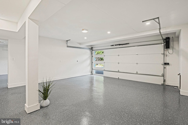 garage with baseboards and recessed lighting