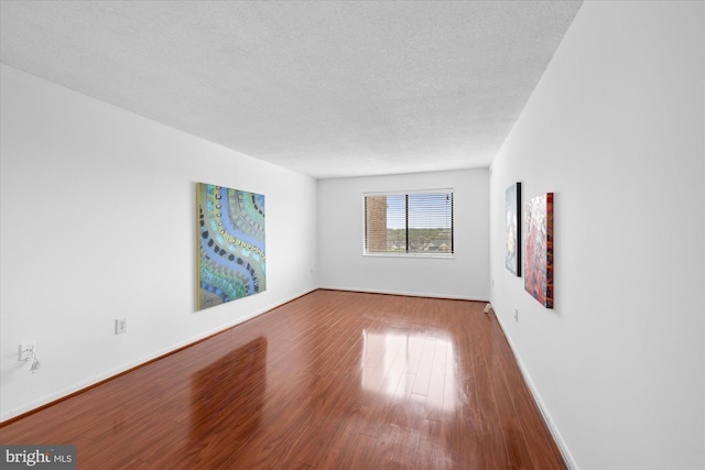 200 N Pickett St N Unit 1513, Alexandria, VA 22304 - spare room with baseboards, wood finished floors, and a textured ceiling