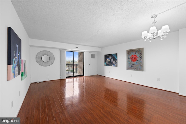 200 N Pickett St N Unit 1513, Alexandria, VA 22304 - unfurnished living room featuring wood finished floors, a textured ceiling, baseboards, and an inviting chandelier