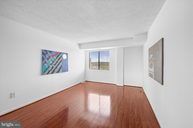 200 N Pickett St N Unit 1513, Alexandria, VA 22304 - unfurnished room featuring baseboards, wood finished floors, and a textured ceiling