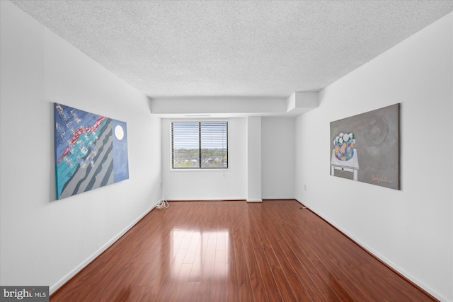 200 N Pickett St N Unit 1513, Alexandria, VA 22304 - unfurnished room with baseboards, wood finished floors, and a textured ceiling