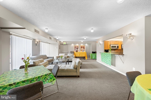 200 N Pickett St N Unit 1513, Alexandria, VA 22304 - carpeted living room with baseboards, visible vents, and a textured ceiling