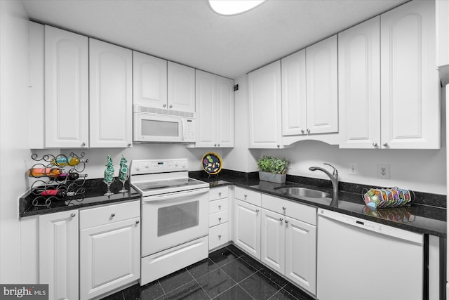 200 N Pickett St N Unit 1513, Alexandria, VA 22304 - kitchen featuring white cabinetry, dark stone counters, a sink, and white appliances