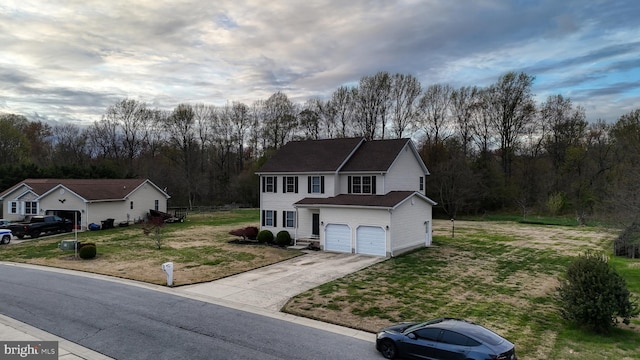 174 W Chestnut Ridge Dr, Magnolia, DE 19962 - traditional home featuring an attached garage, concrete driveway, a front lawn, and view of scattered trees