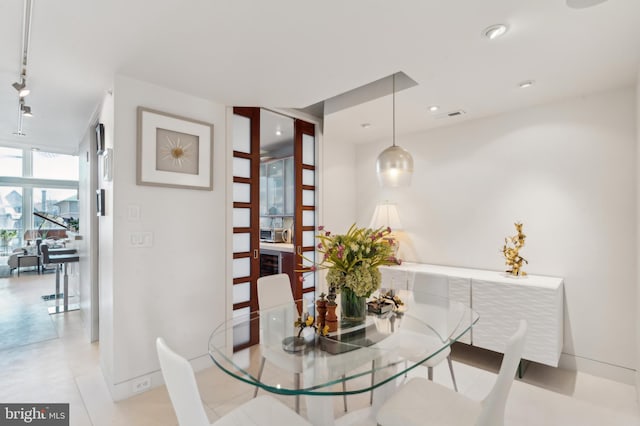 1612 16th St NW Unit 3, Washington, DC 20009 - dining space with rail lighting, a wall of windows, baseboards, and recessed lighting