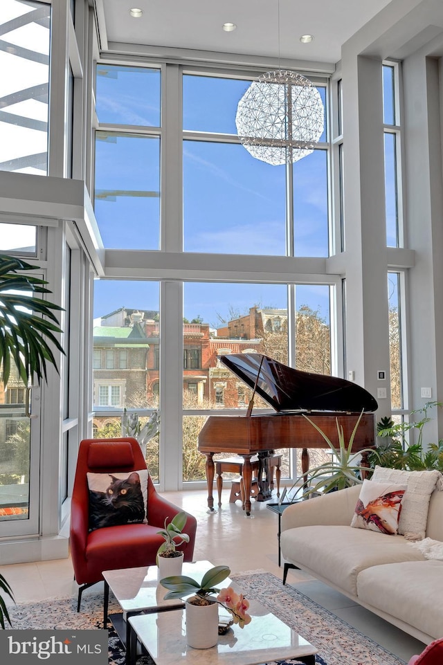 1612 16th St NW Unit 3, Washington, DC 20009 - living room featuring a towering ceiling, expansive windows, a chandelier, and tile patterned floors