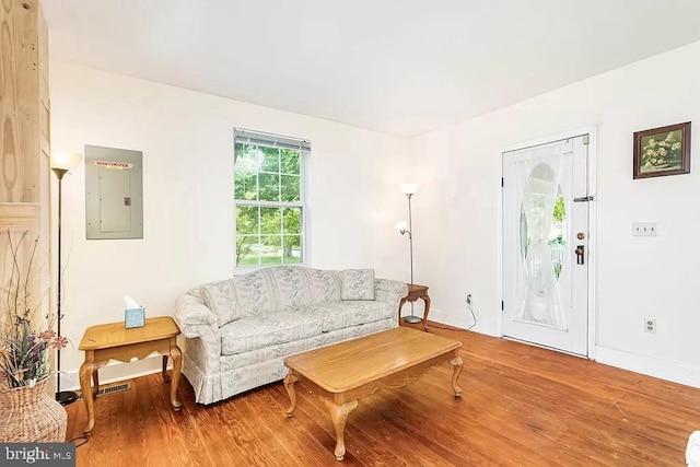 24171 Adelaide St, Parksley, VA 23421 - living area with wood finished floors, visible vents, baseboards, and electric panel