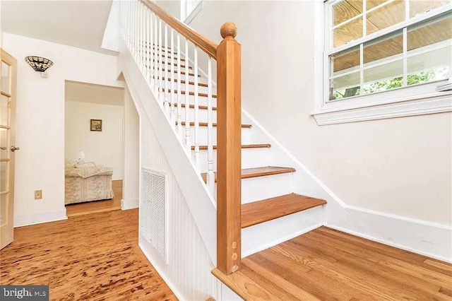 24171 Adelaide St, Parksley, VA 23421 - stairway with baseboards and wood finished floors
