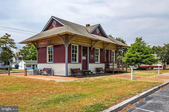 24171 Adelaide St, Parksley, VA 23421 - view of front of home featuring entry steps, a chimney, central AC, a front yard, and a shingled roof