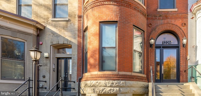 property entrance featuring brick siding and stone siding