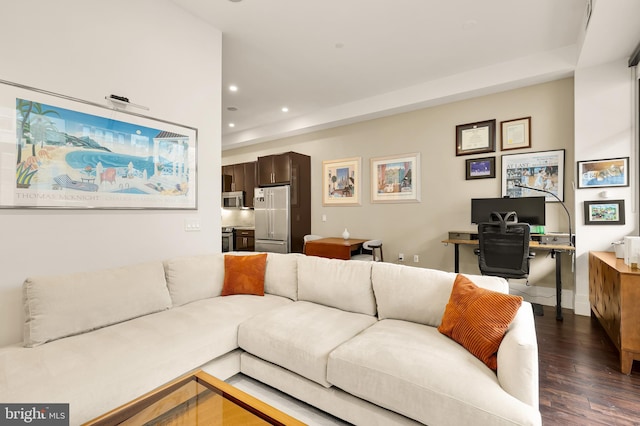 living room with recessed lighting and dark wood-style floors