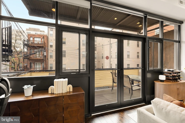 entryway featuring a wall of windows, wood finished floors, and visible vents