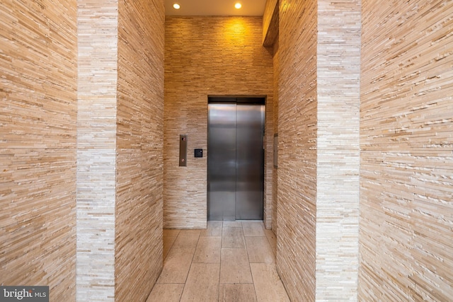 corridor featuring recessed lighting and elevator