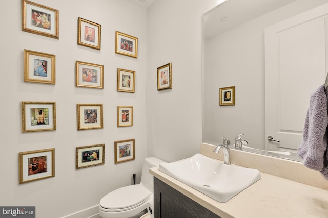 bathroom featuring toilet and vanity
