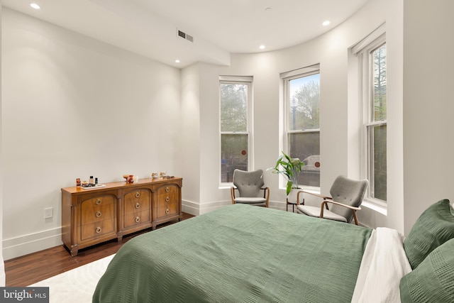 bedroom with baseboards, dark wood-type flooring, recessed lighting, and visible vents