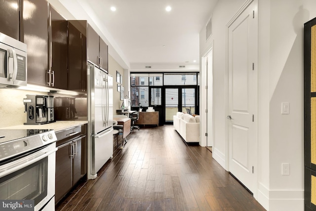 kitchen featuring dark wood-style flooring, stainless steel appliances, dark brown cabinets, and light countertops