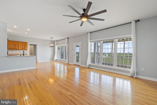 15920 Broadfording Rd, Hagerstown, MD 21740 - unfurnished living room featuring a chandelier, ceiling fan, recessed lighting, baseboards, and light wood-style flooring