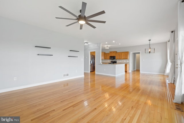 15920 Broadfording Rd, Hagerstown, MD 21740 - unfurnished living room with ceiling fan, light wood finished floors, and baseboards