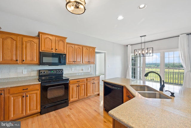 15920 Broadfording Rd, Hagerstown, MD 21740 - kitchen with black appliances, a sink, tasteful backsplash, a chandelier, and light wood-style floors
