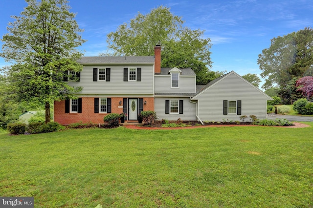 3228 Canterbury Ln, Fallston, MD 21047 - view of front facade featuring a front lawn, a chimney, and brick siding