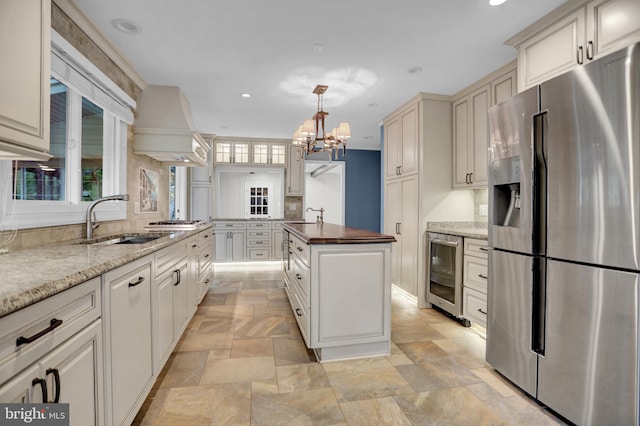 3228 Canterbury Ln, Fallston, MD 21047 - kitchen featuring appliances with stainless steel finishes, wine cooler, a sink, stone tile flooring, and recessed lighting