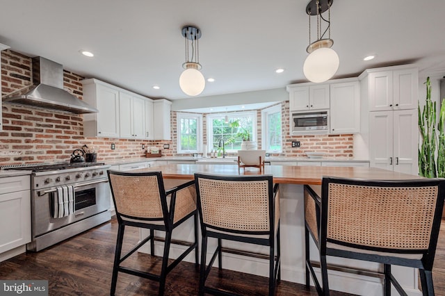 312 Center Hill Rd, Wilmington, DE 19807 - kitchen with wall chimney range hood, stainless steel appliances, light countertops, and white cabinetry