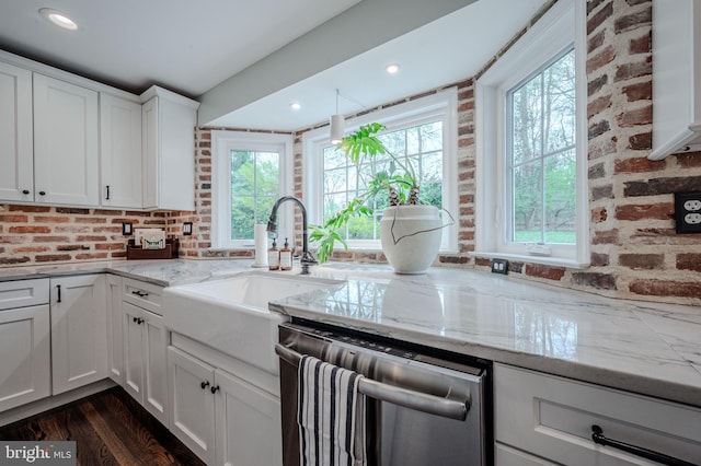312 Center Hill Rd, Wilmington, DE 19807 - kitchen featuring stainless steel dishwasher, brick wall, a sink, and light stone counters