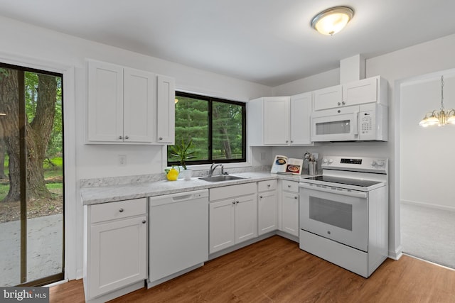 5338 Lightning View Rd, Columbia, MD 21045 - kitchen featuring white appliances, a sink, light countertops, white cabinets, and plenty of natural light