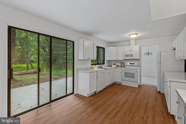 5338 Lightning View Rd, Columbia, MD 21045 - kitchen featuring white appliances, a sink, wood finished floors, and light countertops