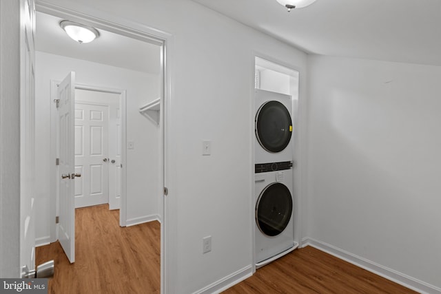 5338 Lightning View Rd, Columbia, MD 21045 - laundry room with estacked washer and dryer, wood finished floors, and baseboards