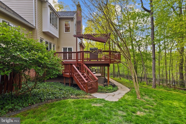 view of play area with a yard, fence, a wooden deck, and stairs